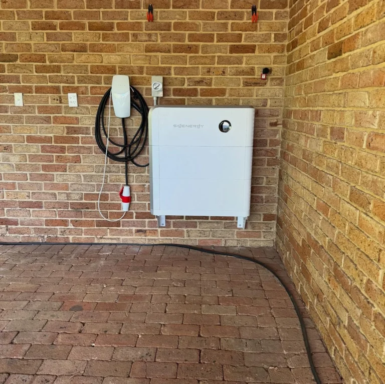 Sigenergy battery and wall-mounted EV charger installed in a brick carport
