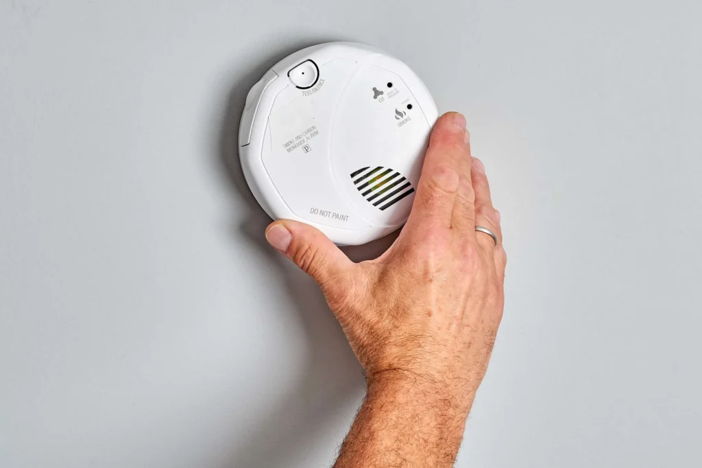 Hard-wired smoke detector installed on residential ceiling for fire safety